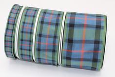 four rolls of blue and green plaid ribbon