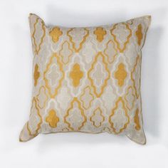 a yellow and white decorative pillow on a white background with an orange geometric design in the middle