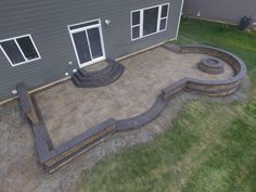 an outdoor patio with steps and fire pit