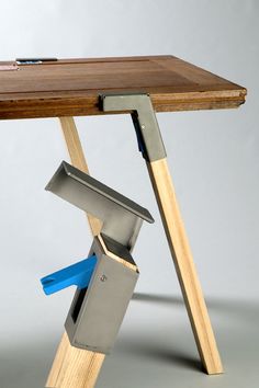 a wooden table topped with a metal knife holder and a cutting board on top of it