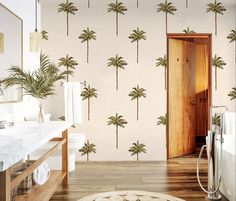 a bathroom with palm trees on the wall