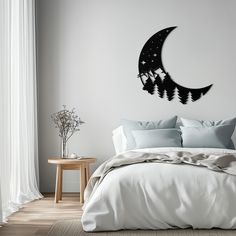 a bedroom with a bed, night sky and stars on the moon wall decal