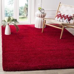 a living room with red carpet and white walls