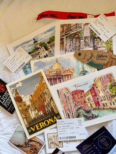 there are many different pictures on the bed sheet that is covered in postcards and paper