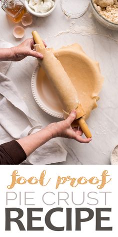 a person holding a piece of bread on top of a table