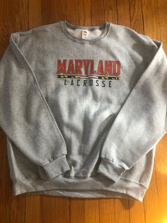 8 oz 50/50 Cotton/Poly Maryland Lacrosse Crew Casual Pre-shrunk Hooded T-shirt, Casual Heather Grey Fan Merchandise Tops, Casual Hooded T-shirt With Logo Print, Heather Grey Cotton Sweatshirt With Logo Print, Cotton Hoodie In Athletic Heather For College, Cotton School Spirit Hoodie For Fans, Casual Sweatshirt With Logo Print For Fans, Casual Pre-shrunk Hoodie For College, Cotton Hooded Top For Fan Merchandise