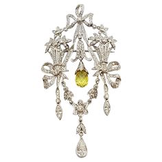 Diamond 1.28 carats with Yellow Sapphire 1.78 carats Brooch/Pendant set in 18 Karat White Gold Settings (chain not included) Width: 3.2 cm Length: 6.0 cm Total Weight: 9.59 grams "We first opened doors in 1980 when it was then situated in the vicinity of the Victory Monument; a small and modest storefront with a couple of counters. From its humble beginnings to where it stands today, our company has proven its abilities as a jeweler. Since the beginning, we have been supplying fine quality piece Yellow Brooch Jewelry For Wedding, Yellow Wedding Jewelry Brooch, Fine Jewelry White Gold Brooch With Brilliant Cut, Fine Jewelry White Gold Brooches With Brilliant Cut, Luxury Diamond Pendant Brooches, Luxury Diamond Brooches, Exquisite White Gold Pendant Brooch, Yellow Gold Diamond Pendant Brooch, Ornate White Gold Diamond Brooch