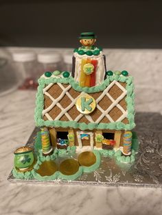 a cake shaped like a house on top of a table