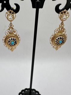 A unique opportunity for a wonderful pair of vintage 14K yellow gold dangle earrings. These unique earrings are hallmarked 14K on the bottom dangle and are guaranteed to be such. These gorgeous earrings have 2 dangles. The top dangle looks like a circle, which houses a 3.3mm pearl and what looks to be a crown. The bottom dangle features an elaborate design with a center blue stone, perhaps a tourquoise? The intricacy of the design is impressive. These are post earrings with butterfly closures. These beauties are 2 3/4" long and just under 3/4" at their widest. They are an impressive 6.31 grams. These are fabulous pair of earrings and perfect for a special occasion or for that person who just wants some thing very different! Antique 14k Gold Hallmarked Earrings, Vintage Yellow Gold Dangle Earrings, Antique Formal Dangle Chandelier Earrings, Antique Dangle Chandelier Earrings For Formal Occasions, Vintage Formal Filigree Chandelier Earrings, Victorian Gold Plug Earrings, Formal Vintage Chandelier Earrings, Ornate Hallmarked Dangle Chandelier Earrings, Ornate Hallmarked Chandelier Dangle Earrings