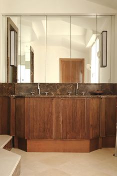 a bathroom with two sinks and mirrors in it