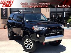 a black toyota 4runner is parked in front of a building with the words leggy cars on it