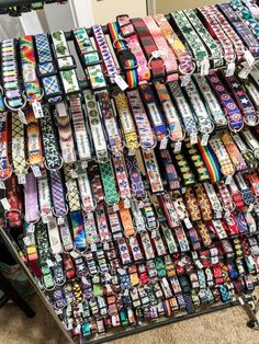 many different types of bracelets are stacked on top of each other in a store