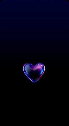 a heart shaped object in the middle of a dark background with blue and pink colors