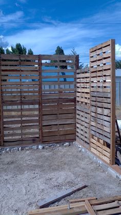 a wooden fence that is in the dirt