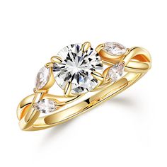 a yellow gold engagement ring with two pear shaped diamonds