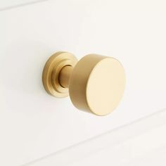 a close up of a knob on a white door