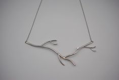 "Inspired by our bestselling line of Roots Rings, this Branch Rhodium Roots Necklace with Moissanite is the perfect necklace to complete your bridal look. It is made from sterling silver.  The branch pendent is about 5\" long and about 2\" from the bottom to the tallest branch. This pendent comes on a an adjustable silver 22\" snake chain. The chain has a silicon ball. The chain threads through this ball and can be pushed and pulled on for east adjustment. This makes this necklace great for layering with others.   Sterling silver is the base metal for these earrings. They are then plated with platinum to prevent tarnishing. The platinum also allows us to plate the ring with gold finishes. This ring is finished in white gold. This necklace features a Moissanite. Moissanite is a lab created Sterling Silver Nature-inspired Necklace For Anniversary, Nature-inspired Sterling Silver Necklace For Anniversary, Nature-inspired White Gold Jewelry For Formal Occasions, Sterling Silver Diamond Necklace For Wedding, Nature-inspired Sterling Silver Wedding Necklaces, Nature-inspired Jewelry With Single Cut Diamonds As Gift, Nature-inspired Jewelry With Single Cut Diamonds For Gifts, Nature-inspired Sterling Silver Wedding Necklace, Nature-inspired Sterling Silver Necklace For Weddings