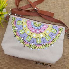 a white purse with a colorful design on it