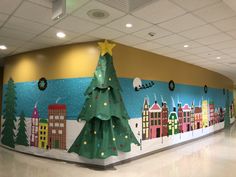 a decorated wall with a christmas tree in the center and cityscape on it