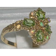 *This unique ring is made from Solid 9K Yellow Gold with Genuine Precious Peridots and colorful Opals.*Total Height 4mm, Width 15mm, Length 17mm This Unique ring is Handcrafted from Solid English 9K Yellow Gold, Handset with exquisite precious gemstones and fully tested and Hallmarked by the London Assay Office, giving you the assurance of a high quality timeless piece.This impressive ring is handset Natural Peridots & Opals - Four Oval cut 5x4mm (0.20" x 0.16" inches) Natural Peridots and f Gold Cluster Rings With Gemstone Accents, Green Cluster Multi-stone Rings, Luxury Cluster Multi-stone Green Rings, Heirloom Green Cluster Ring, Multi-stone Green Diamond Ring In 14k Gold, Green Multi-stone Diamond Ring In 14k Gold, Green Multi-stone 14k Gold Diamond Ring, Green Cluster Rings In 14k Gold, Green 14k Gold Cluster Ring