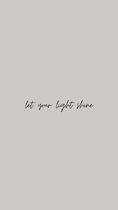 the words let your light shine are written in black ink on a gray background with a white