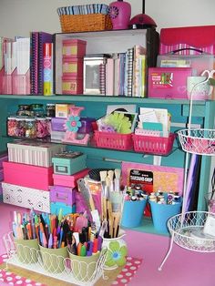 a desk with lots of colorful items on it and some baskets filled with pens, pencils and markers