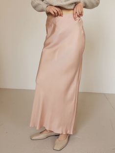 Light pink 90's inspired bias cupro maxi skirt with side zipper closure. Style with your favorite sweaters and ballet flats. CONTENT + CARE 60% Cupro | 40% Viscose SIZE + FIT Model is wearing a size small. S (2-4), M (6-8), L (10-12) Spring Full-length Satin Skirt, Spring Satin Maxi Skirt, Spring Maxi Length Satin Skirt, Chic Pink Maxi Length Skirt, Chic Pink Maxi Skirt, Spring Chic Ankle-length Maxi Skirt, Spring Bias-cut Long Skirt Bottoms, Chic Bias Cut Maxi Length Bottoms, Chic Full Length Bias Cut Maxi Skirt