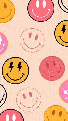 many different colored smiley faces on a pink background