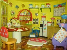 a doll house kitchen with yellow walls and furniture