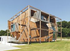 a wooden structure sitting on top of a lush green field