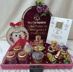 an assortment of decorative items displayed in a display case on a white cloth covered table