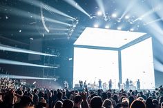 a large group of people standing on top of a stage in front of a crowd