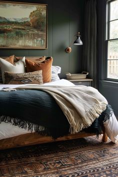 a bedroom with dark green walls and a large painting on the wall above the bed