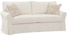 a white couch with two pillows on it