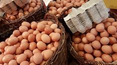 baskets filled with eggs sitting on top of a table