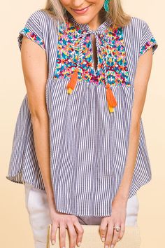 Pinata Embroidery Top :: NEW ARRIVALS :: The Blue Door Boutique Blue Spring Tops With Tassel Ties, Blue Spring Top With Tassel Ties, Bohemian Striped Cotton Tops, Summer Cotton Tops With Tassels, Cotton Tops With Tassels For Vacation, Cotton Summer Top With Striped Hem, Cotton Beach Tops With Tassels, Summer Cotton Top With Striped Hem, Embroidered Striped Cotton Tops