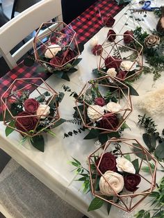 some flowers and greenery on a table