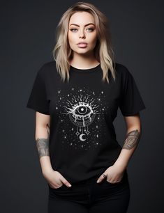 Get 10% off your first order: join.lucidamystica.com Mystical evil eye celestial design on a super-soft unisex tshirt in Black. Will become your next wardrobe staple as it feels super-soft and worn in. Comes in plus sizes for a roomy fit.  Perfect for yourself or as a gift for your favorite witchy human.   Size up for an oversized aesthetic fit, size chart found in images. Printed on a super-soft Bella Canvas 3001 tshirt. + Printed on Bella + Canvas 3001 unisex tshirt + Retail fit + 100% Soft co Mystical Cotton Crew Neck T-shirt, Mystical Short Sleeve Top With Graphic Print, Mystical Crew Neck Cotton T-shirt, Mystical Graphic Print Short Sleeve Top, Mystical Style Cotton T-shirt With Crew Neck, Mystical Graphic Print Crew Neck Top, Mystical Style Cotton Crew Neck T-shirt, Mystical Black Top With Graphic Print, Mystical Black Tops With Graphic Print