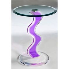 a glass table with a blue wave design on the top and bottom, sitting in front of a white background