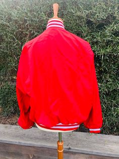 "Pla-Jac by Dunbrooke Red Jacket This jacket was made in the USA and marked a size medium. It reads City of Irvine Community Services 1971 The jacket measures 24\" long with 24\" sleeve when lying flat there's 17\" between shoulder seams and 22\" in the chest" Red Vintage Winter Track Jacket, Vintage Red Track Jacket For Winter, Red Vintage Track Jacket For Winter, Vintage Red Long Sleeve Track Jacket, Retro Red Windbreaker For Fall, Red Vintage Windbreaker For Winter, Vintage Red Varsity Jacket With Long Sleeves, Vintage Red Long Sleeve Outerwear, Retro Red Outerwear For Spring