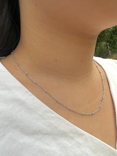 Item Details: This Silver Satellite Bead Chain Necklace is resistant to tarnish and adjustable in length, making it comfortable and fitting for all neck sizes. Model in photo is wearing a size 18 inches (45 cm). Materials: rhodium plated brass  Length (adjustable):     ○ 18 to 20 inches    ○ 45 to 50 cm Care Instructions: To maintain shine and condition,    ○ Keep away from long term water exposure    ○ Remove during bathing, exercise, etc.    ○ Clean and polish with soft cloth * US customers: Receive FREE US shipping by making an order of $35 or above from my shop. * Non-US customers: If you order multiple items from my shop at once, the shipping cost will be for one piece. If you have any questions or concerns, please don't hesitate to contact me. Silver Satellite Bead Chain Necklace/Dai Adjustable Silver Necklace With Satellite Chain, Trendy Silver Beaded Necklace With Adjustable Chain, Trendy Silver Necklaces With Round Beads, Gift Beaded Necklace With Ball Chain, Minimalist Adjustable Chain Necklace With Round Beads, Adjustable Silver Jewelry With Satellite Chain, Minimalist Adjustable Round Bead Chain Necklace, Delicate Adjustable Silver Chain Necklace, Adjustable Silver Satellite Chain Necklace