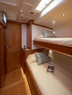 there are two bunk beds in the cabin on this boat that is built into the wall