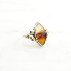 This ring is a size 7 1/4 (USA); It may be resized. Markings: Sterling & 10K, C& (Tested & guaranteed to be Sterling Silver) This ring weighs 2.9 Grams The Stone/Design is  Dendric Agate 10K Gold Accents   Natural  The Stone/Design measures 16.2 x 7.3 mm The condition of this ring is Estate, Great, moderate patina This vintage item is circa 1920  To have us do the resize, add this listing and the resize listing to your cart and select which size you would like this ring to be on the resize listing which may be accessed through this link: https://www.etsy.com/listing/780307949/simple-silver-ring-resize For more vintage sterling silver rings please visit:  https://www.etsy.com/shop/SilverStarrs925?section_id=13854217 Thank you for viewing my item!  Favorite the store to get updates when item Antique Oval Collectible Rings, Art Deco Rings With Oval Cabochon Polished Finish, Art Deco 14k Gold Cabochon Ring, Art Deco 14k Gold Rings With Cabochon, 14k Gold Art Deco Rings With Cabochon, Antique Hallmarked Oval Cabochon Rings, Antique Cabochon Rings For Anniversary, Art Deco Cabochon Ring For Anniversary, Art Deco Hallmarked Ring With Oval Cabochon