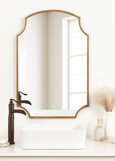 a bathroom sink with a mirror above it and a faucet next to it