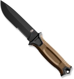 a large knife with a brown handle and black blade on it's end, against a white background