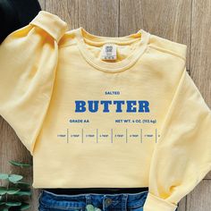 Funny Salted Butter Sweatshirt About Comfort Colors Sweatshirt: Luxurious comfort and style are what this unisex, garment-dyed sweatshirt is all about. It's made with 80% ring-spun cotton and 20% polyester and the fabric is 3-end garment-dyed, ring-spun, color-blast fleece with a 100% cotton face. Each sweatshirt comes with a relaxed fit, a rolled-forward shoulder, and a back neck patch.  Sizing Chart: Use the sizing chart to understand the measurement of our crewnecks. For the oversized look, p Butter Sweatshirt, Y2k Fall Outfits, Funny Baking, Gifts For A Baker, Trendy Sweaters, Coat Outfits, Funny Sweatshirts, Plus Size Top, Salted Butter