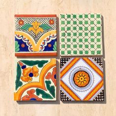 four colorful tiles are arranged on the wall