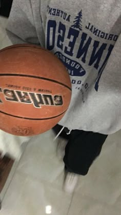 a person holding a basketball in their hand with the word denver written on it's side