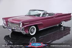 an old fashioned car is on display in a showroom with black marble flooring