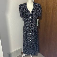 Nwt Vintage Caroline Wells Navy Floral Button Down Maxi Dress Size 12 But Runs Small So See Pics For Measurements. The Pearl Buttons Are Functional And It Has Shoulder Pads That You Could Take Out. Vintage V-neck Buttoned Midi Dress, Vintage V-neck Midi Dress With Buttons, Fitted Floral Print Button-up Dresses, Casual Fitted Midi Dress With Covered Buttons, Casual Fitted Dress With Covered Buttons, Spring Midi Dress With Buttons In Rayon, Spring Rayon Midi Dress With Buttons, Rayon Midi Dress With Button Closure And Short Sleeves, Short Sleeve Rayon Midi Dress With Button Closure